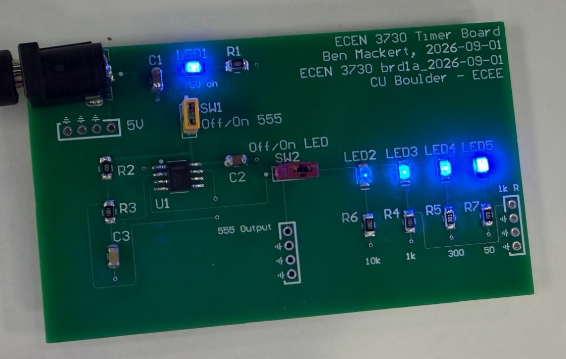 Business-card PCB with a 555 timer driving four blue LEDs of different brightness